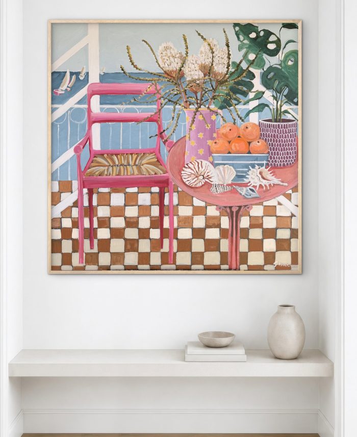 Gracie through room workers chair and table with bowl of oranges and plant